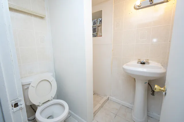 a bathroom with a sink a toilet and a mirror