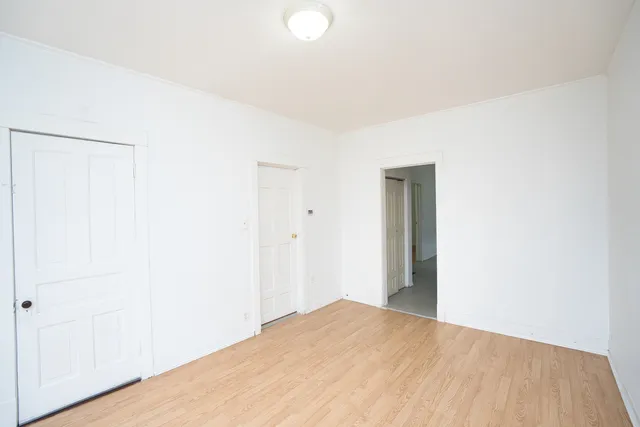 a view of a big room with closet and wooden floor