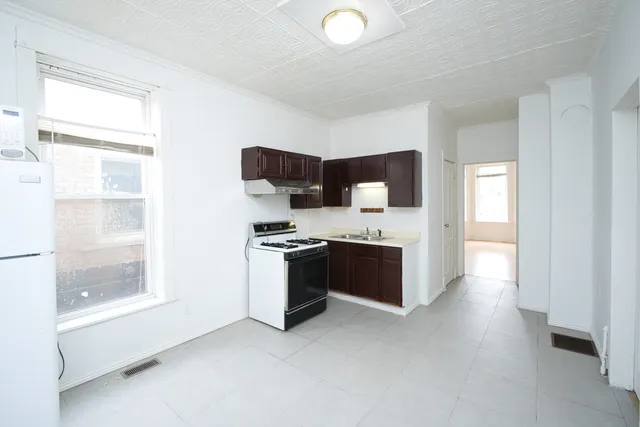 a kitchen with a stove and a refrigerator