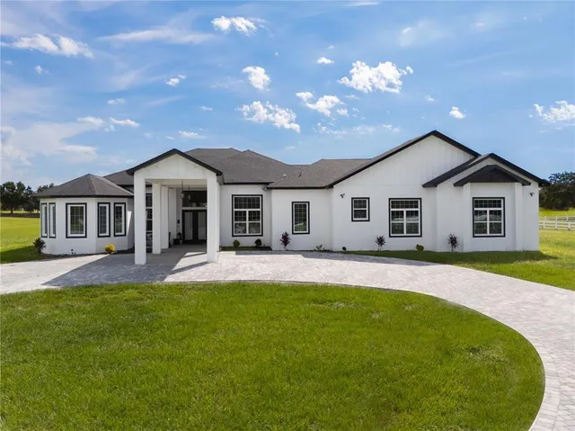 a front view of a house with a yard and porch