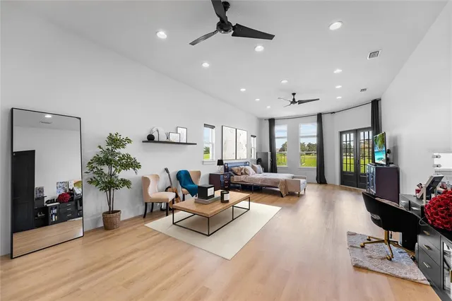 a bathroom with a granite countertop double vanity sink a mirror and a bathtub
