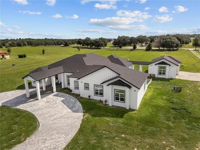 a aerial view of a house with a big yard