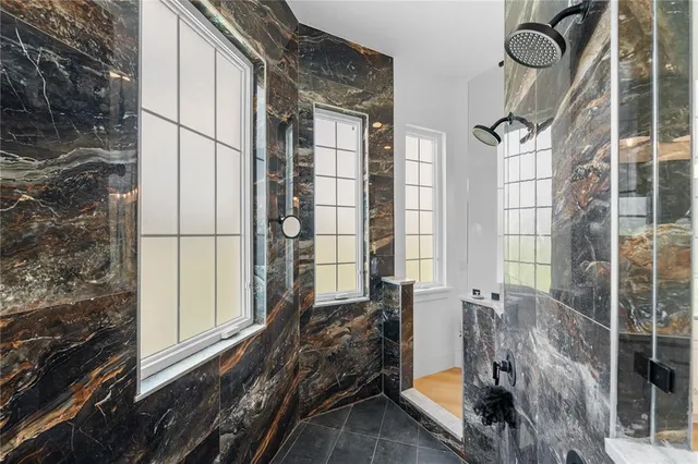 a large white kitchen with a sink and a stove with wooden floor