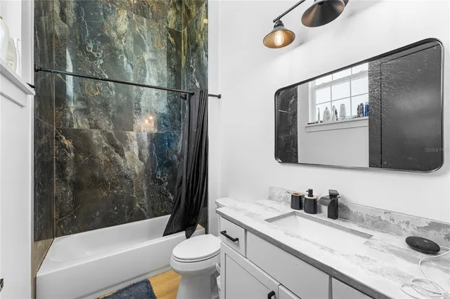 a bedroom with a bed and a dresser