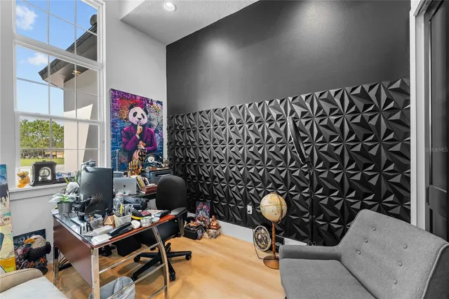 a bedroom with furniture and a flat screen tv