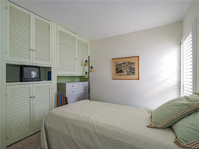 a bedroom with a bed and a tv