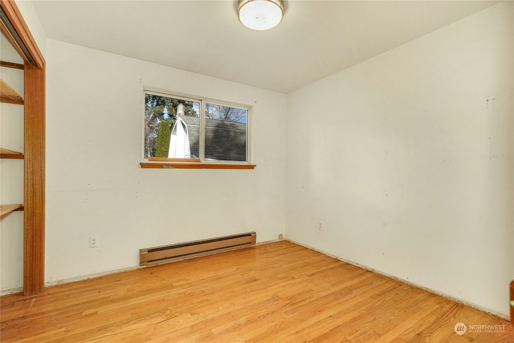17316 North Road Bothell, WA 98012 - Photo 14 of 32 a view of a room with a wooden floor and a window