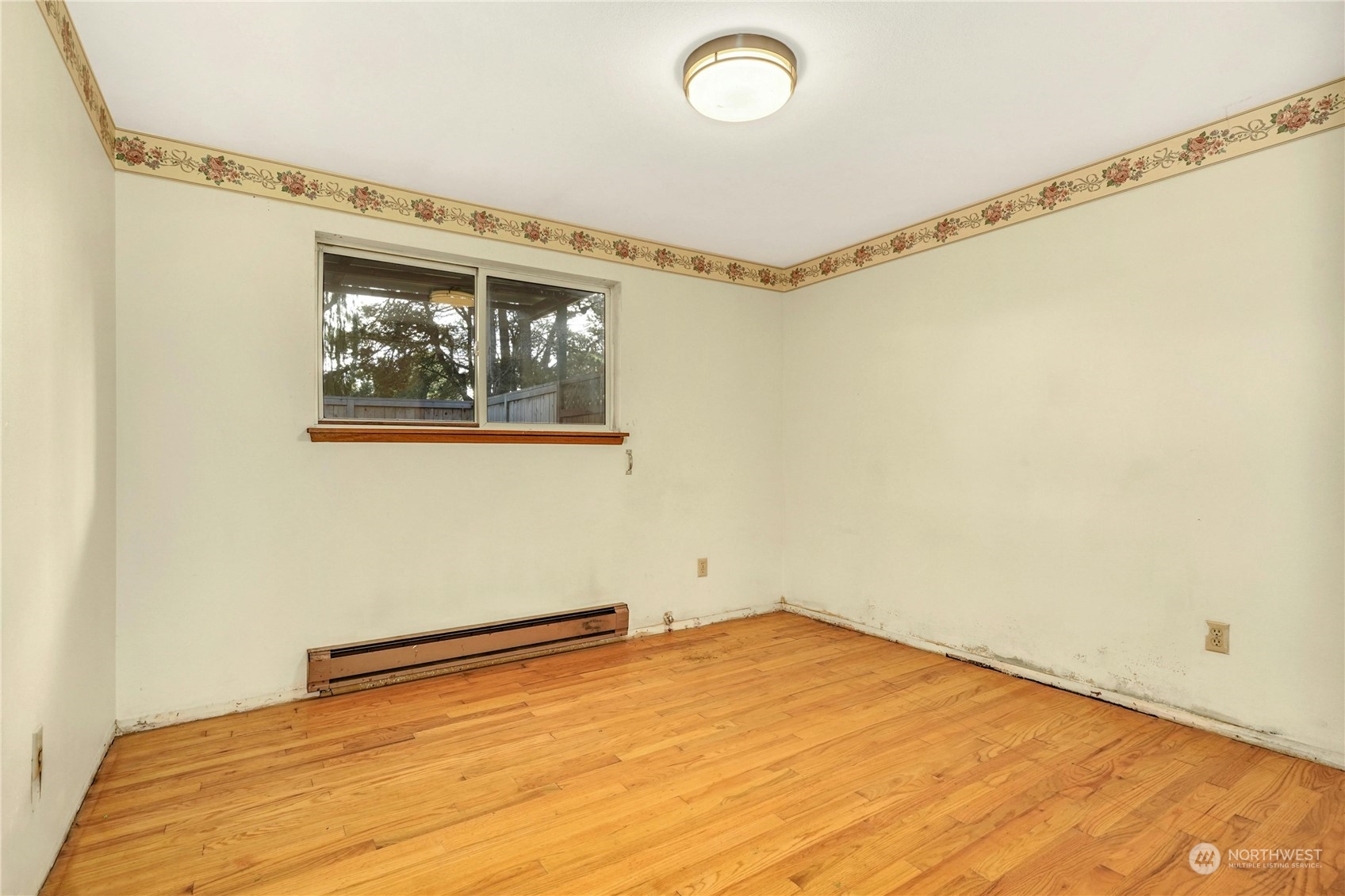 17316 North Road Bothell, WA 98012 - Photo 15 of 32 a view of a room with wooden floor and a window