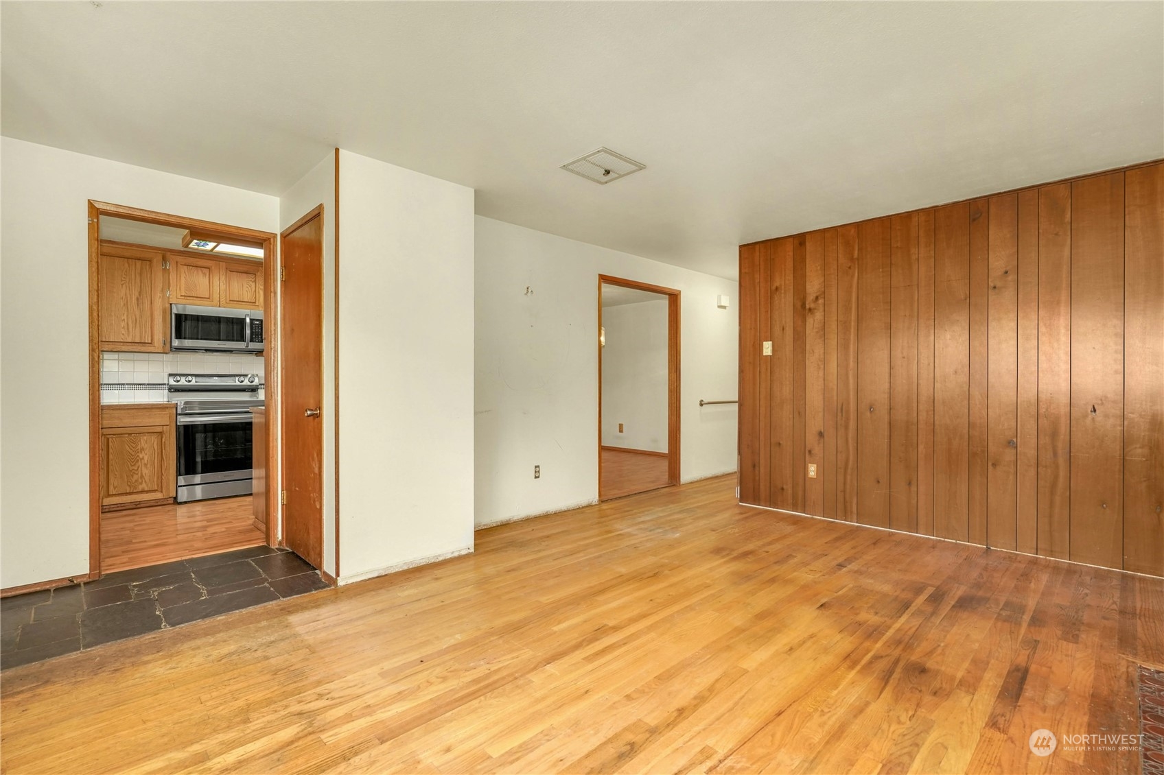 17316 North Road Bothell, WA 98012 - Photo 7 of 32 a view of an empty room with kitchen and a sink