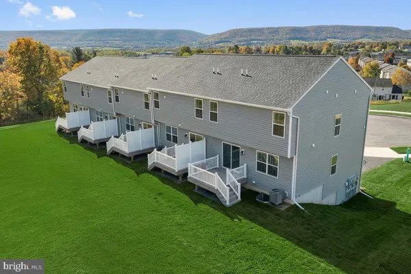 an aerial view of a house with a garden and deck
