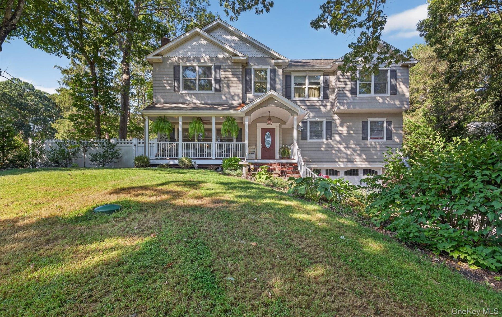 a front view of a house with swimming pool and garden