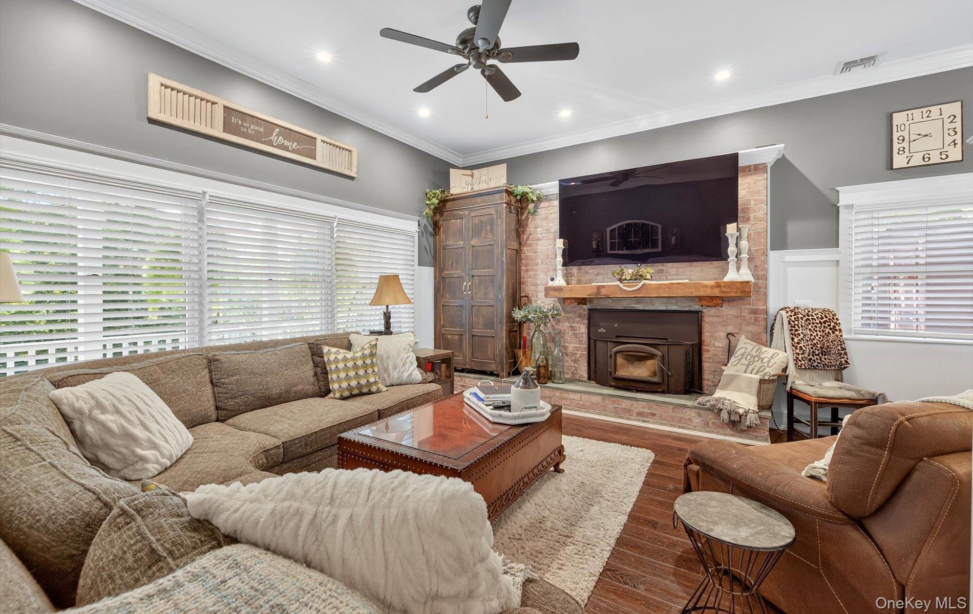 171 Dix Hills Road Dix Hills, NY 11746 - Photo 13 of 39 a living room with furniture a flat screen tv and a fireplace