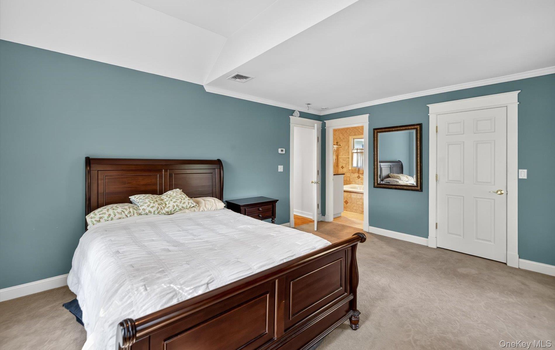 171 Dix Hills Road Dix Hills, NY 11746 - Photo 23 of 39 a bedroom with a bed and wooden floor