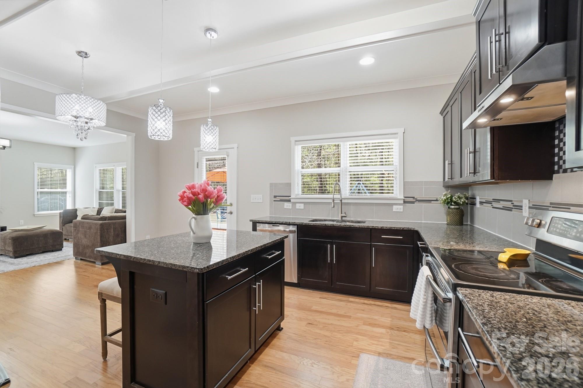 2153 Bluebell Way Tega Cay, SC 29708 - Photo 14 of 48 a kitchen with stainless steel appliances granite countertop a sink counter space and a stove