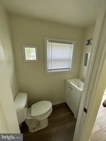 a white toilet sitting next to a bathroom sink