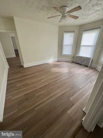 a view of livingroom with hardwood floor and a ceiling fan