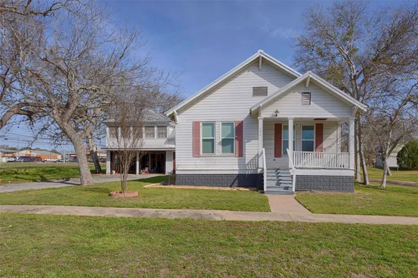 a front view of house with yard and green space