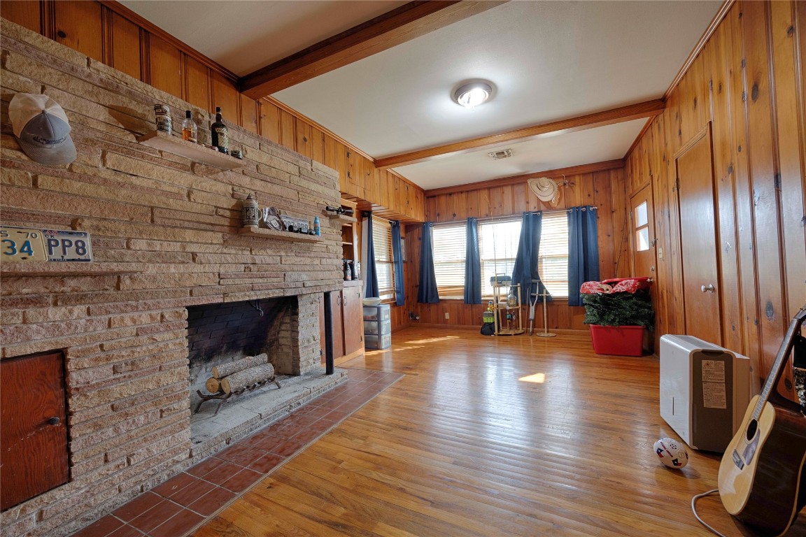 309 Anderson Street Schulenburg, TX 78956 - Photo 11 of 19 a living room with furniture wooden floor and a fireplace
