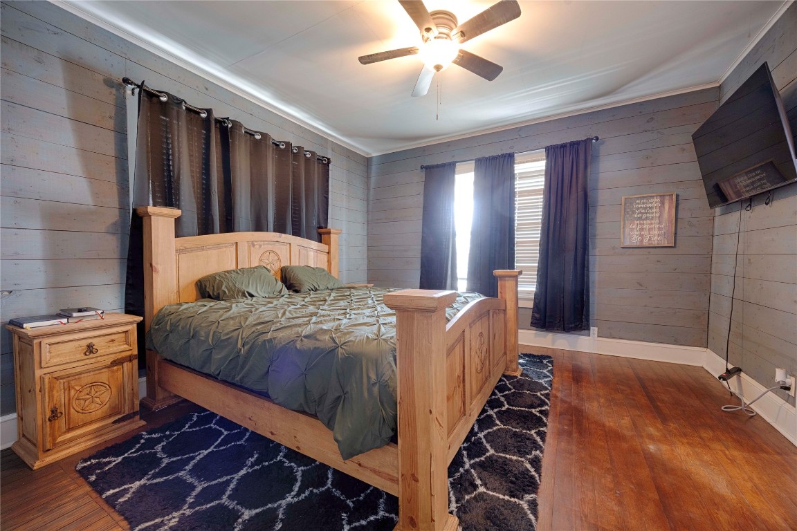 309 Anderson Street Schulenburg, TX 78956 - Photo 13 of 19 a bedroom with a bed and a flat screen tv