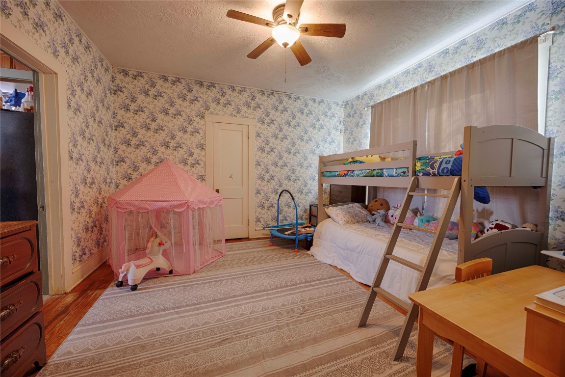 309 Anderson Street Schulenburg, TX 78956 - Photo 14 of 19 a bedroom with furniture and a chandelier