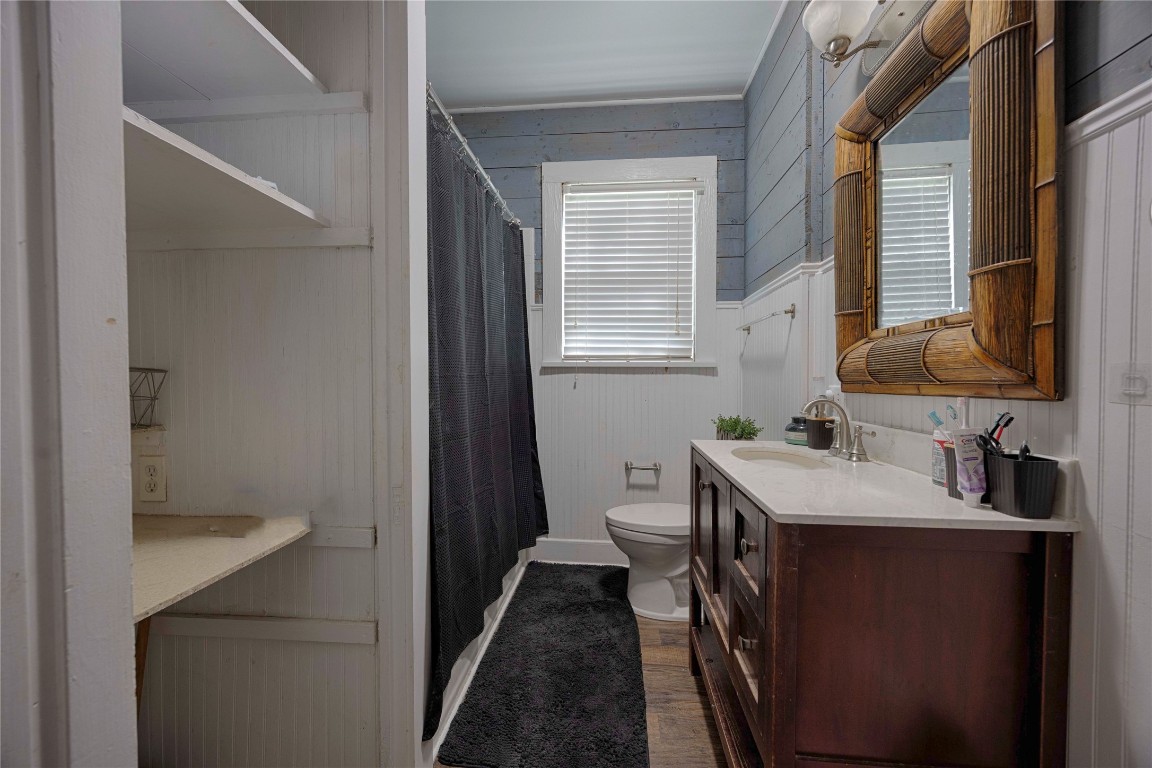 309 Anderson Street Schulenburg, TX 78956 - Photo 15 of 19 a en suite bathroom with a sink a toilet a mirror and window