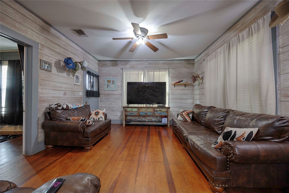 309 Anderson Street Schulenburg, TX 78956 - Photo 3 of 19 a living room with furniture and a flat screen tv