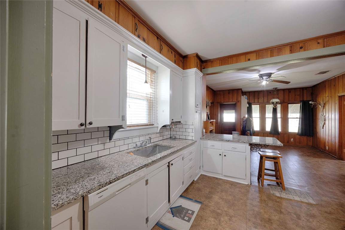 309 Anderson Street Schulenburg, TX 78956 - Photo 7 of 19 a kitchen with stainless steel appliances granite countertop a sink a stove and cabinets