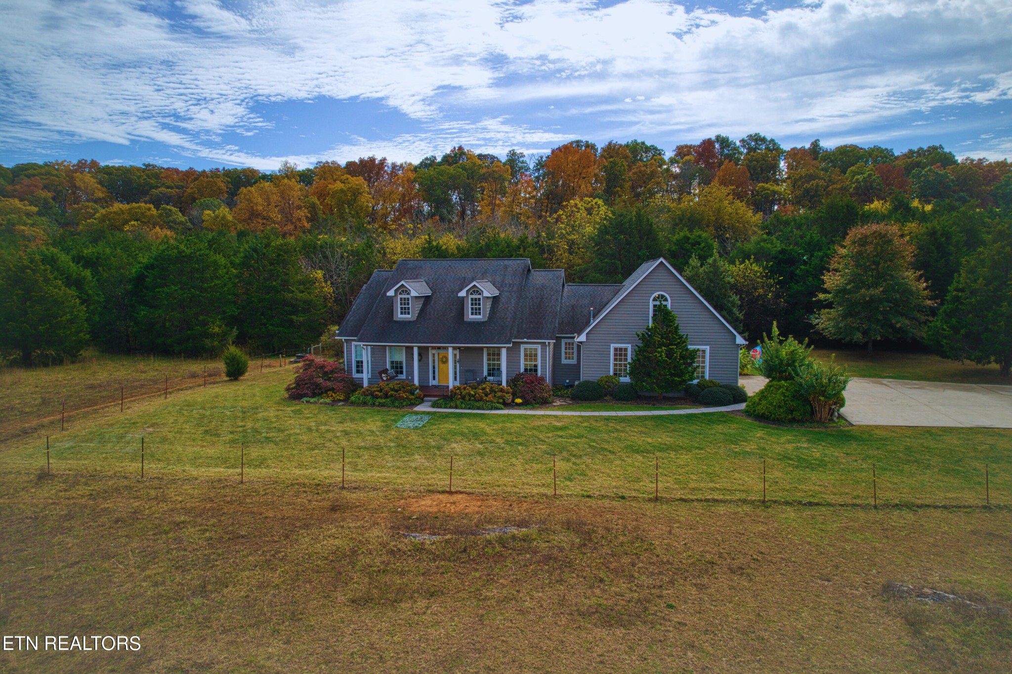 a house with green field in front of it