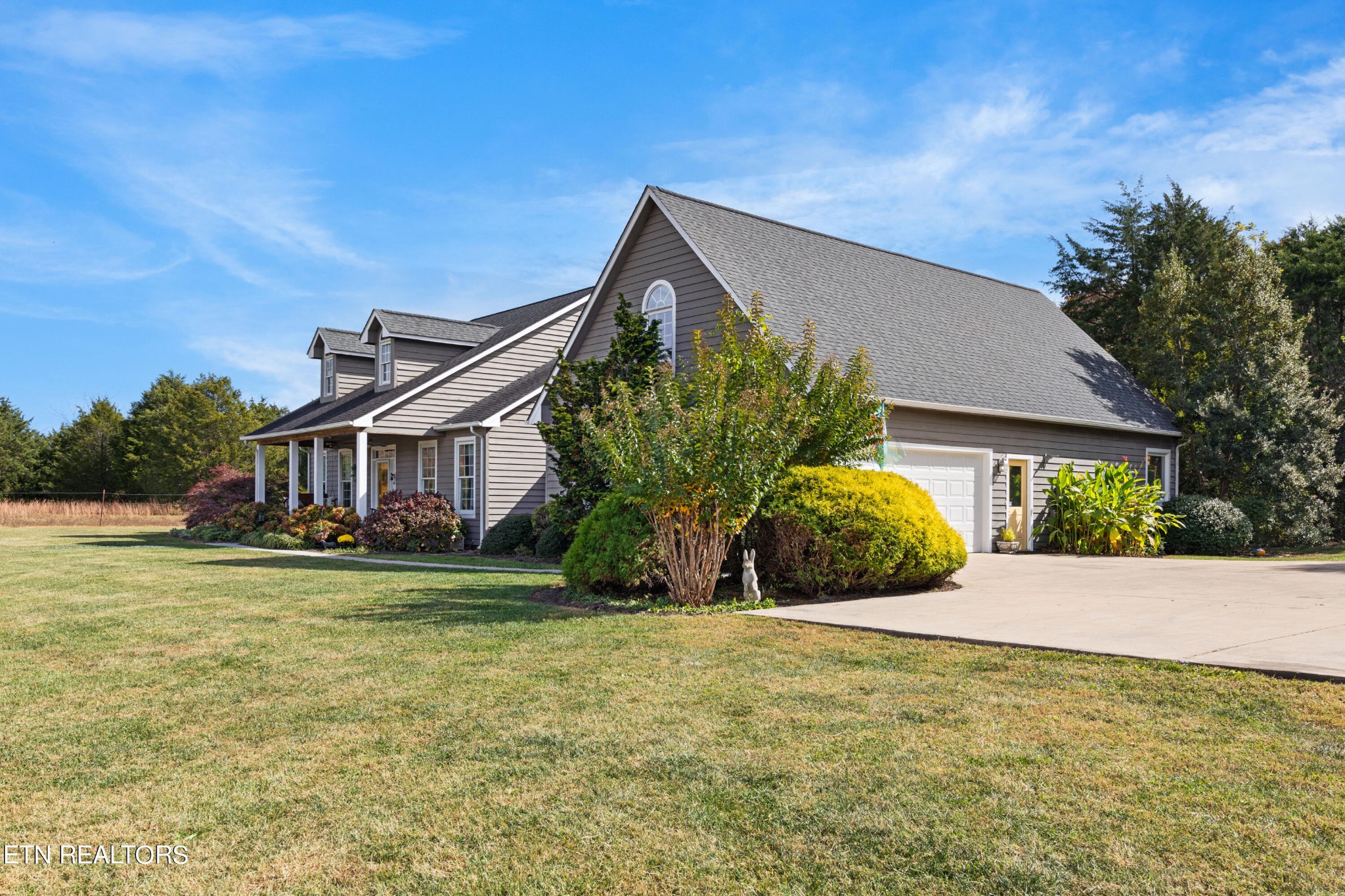 1443 West Dumplin Valley Road Dandridge, TN 37725 - Photo 3 of 51 a front view of a house with a yard