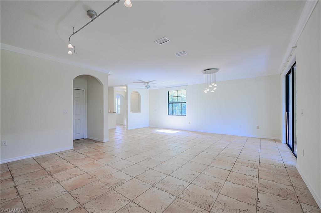 15056 Summit Pl Circle, Unit 228 Naples, FL 34119 - Photo 12 of 27 a view of a big room with windows and chandelier fan