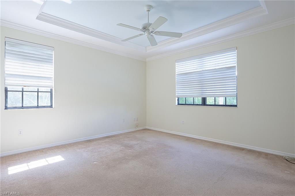 15056 Summit Pl Circle, Unit 228 Naples, FL 34119 - Photo 15 of 27 an empty room with a window and a ceiling fan