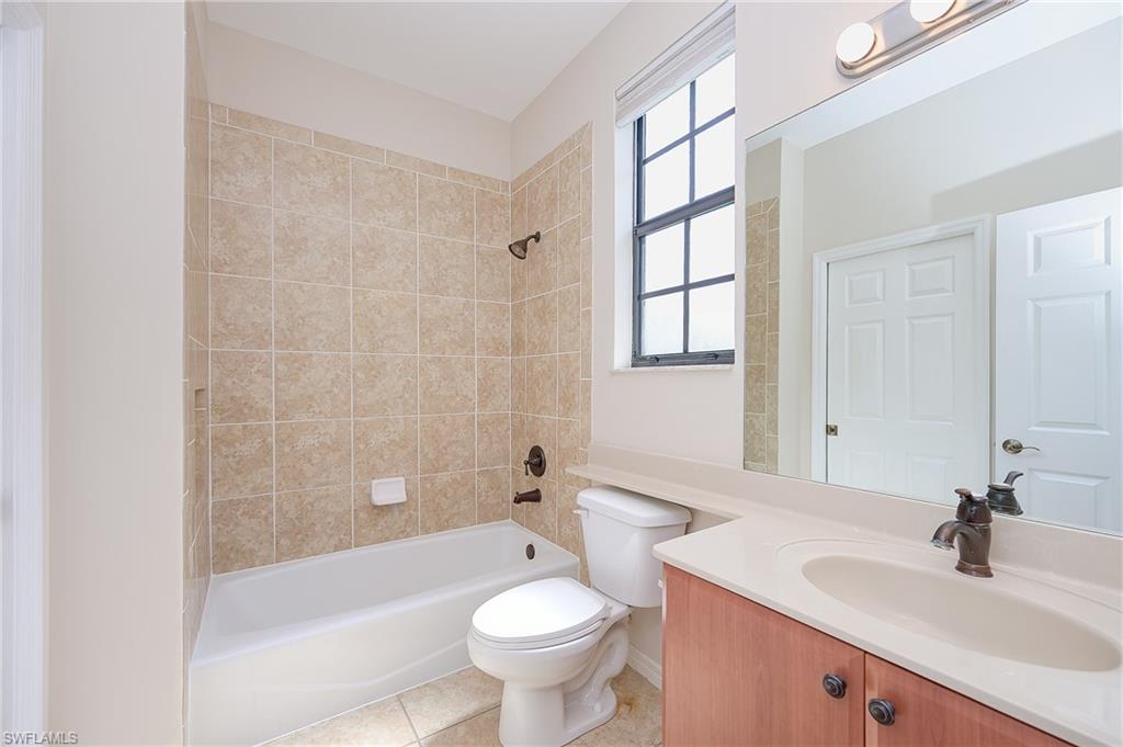 15056 Summit Pl Circle, Unit 228 Naples, FL 34119 - Photo 21 of 27 a bathroom with a sink a toilet and shower