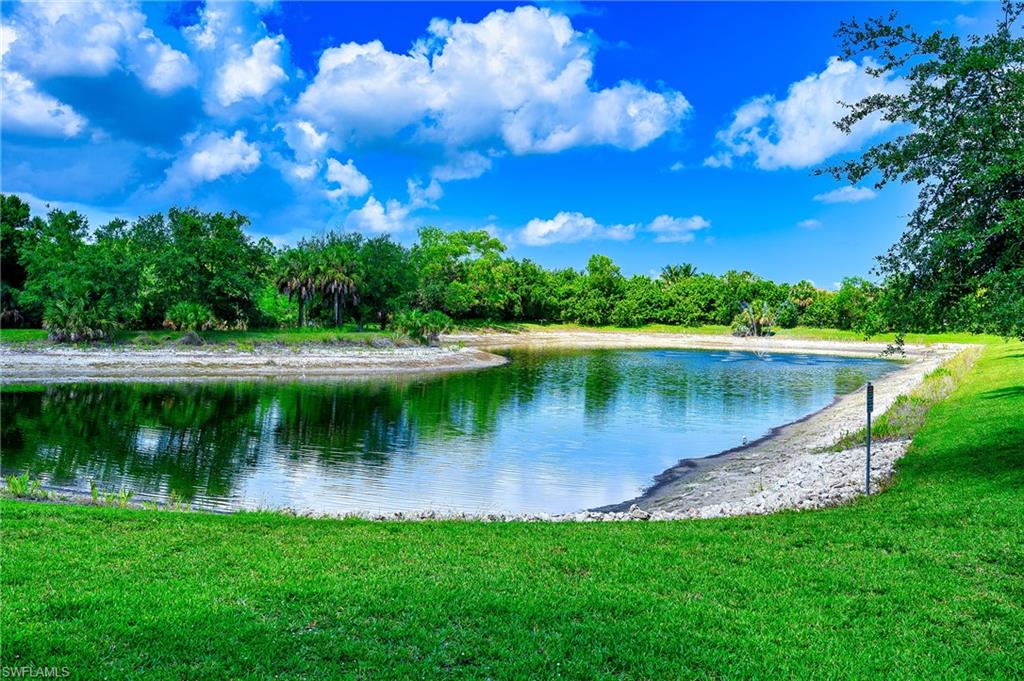 15056 Summit Pl Circle, Unit 228 Naples, FL 34119 - Photo 26 of 27 a view of a lake with a big yard