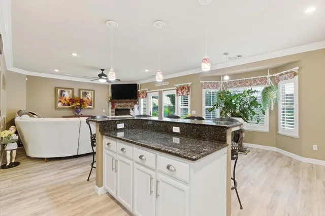 a kitchen with granite countertop a sink and a stove top oven