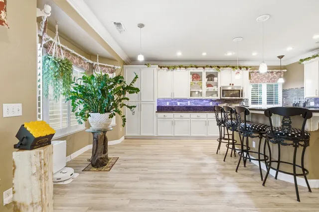a dining room with furniture and wooden floor