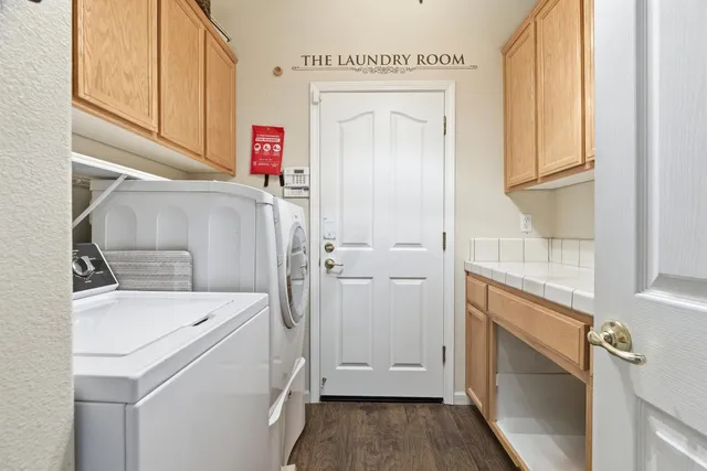 a utility room with a sink dryer and washer