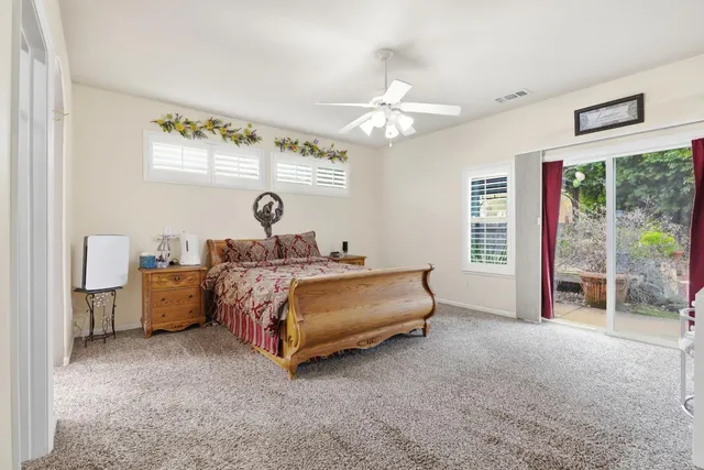 a spacious bedroom with a bed and a chandelier