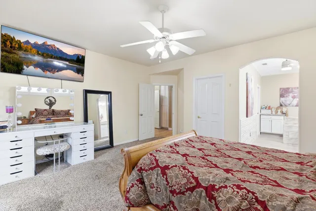 a bedroom with a bed and a chandelier
