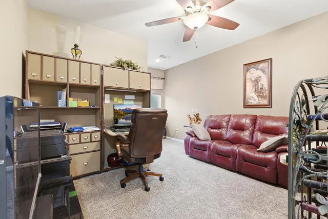 a view of a livingroom with workspace and a couch