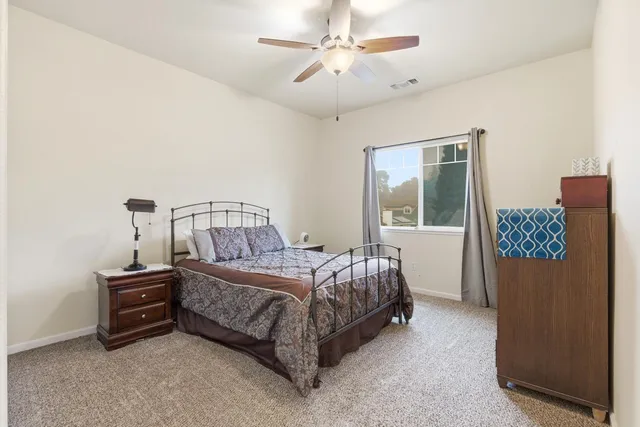a bed sitting in a bedroom next to a window