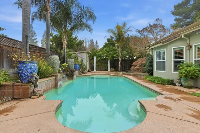 a swimming pool with outdoor seating and yard