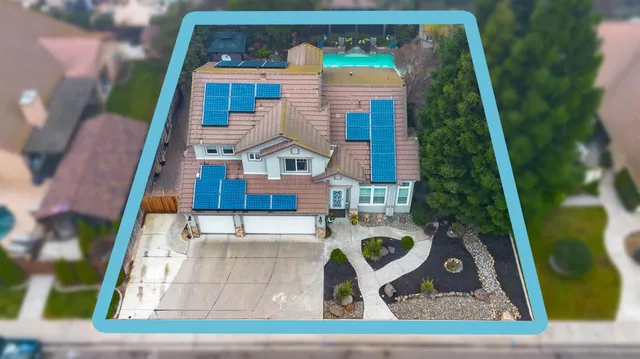 a front view of a house with plants and garden