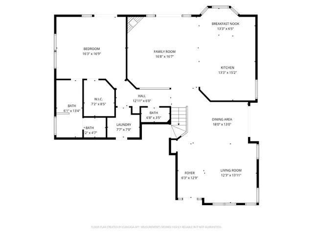 a view of a house with a yard and large trees