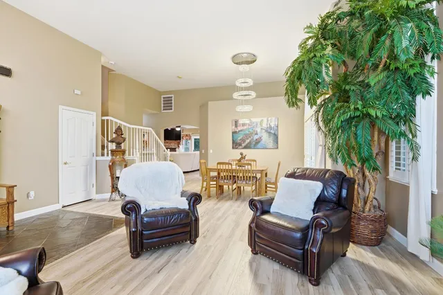 a living room with furniture and a potted plant