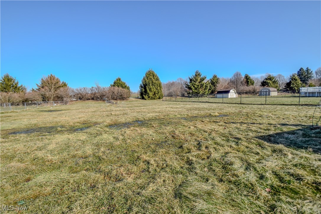 643 Wood Ridge Road Geneva, OH 44041 - Photo 21 of 24 View of yard featuring a rural view and fence