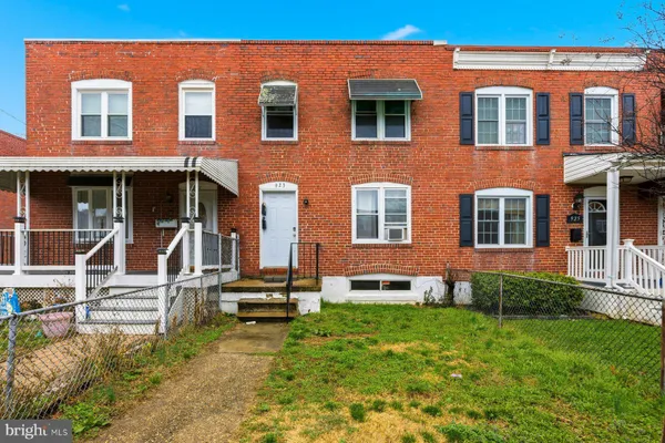 front view of a brick house with a yard