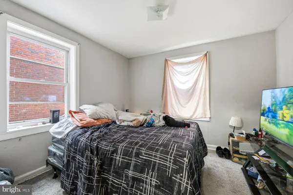 a bathroom with a sink vanity mirror and toilet