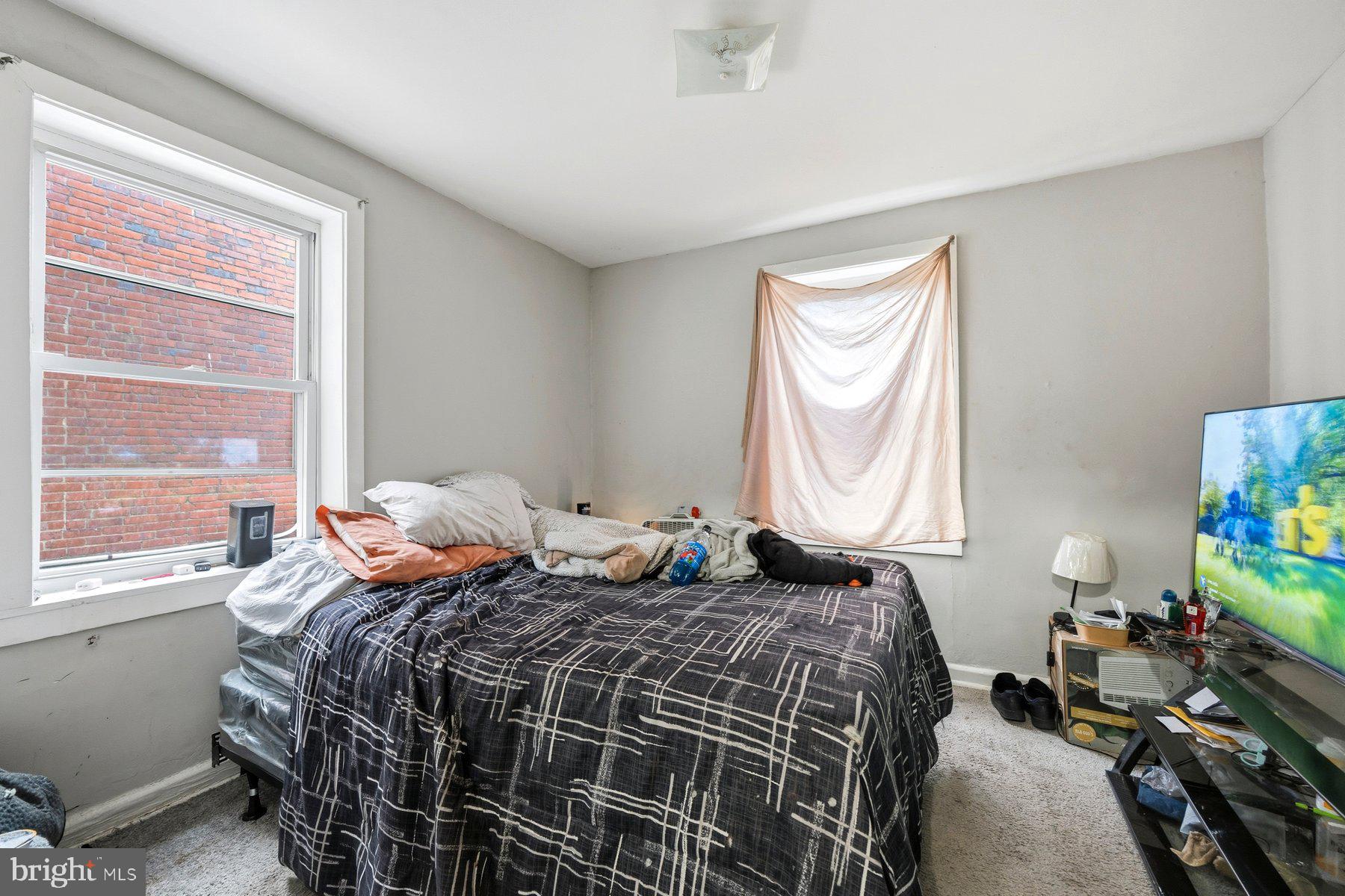 923 1st Street Baltimore, MD 21225 - Photo 11 of 32 a bedroom with a bed and windows