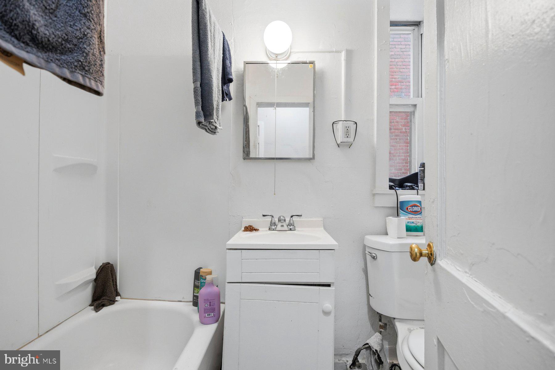 923 1st Street Baltimore, MD 21225 - Photo 12 of 32 a bathroom with a sink vanity mirror and toilet