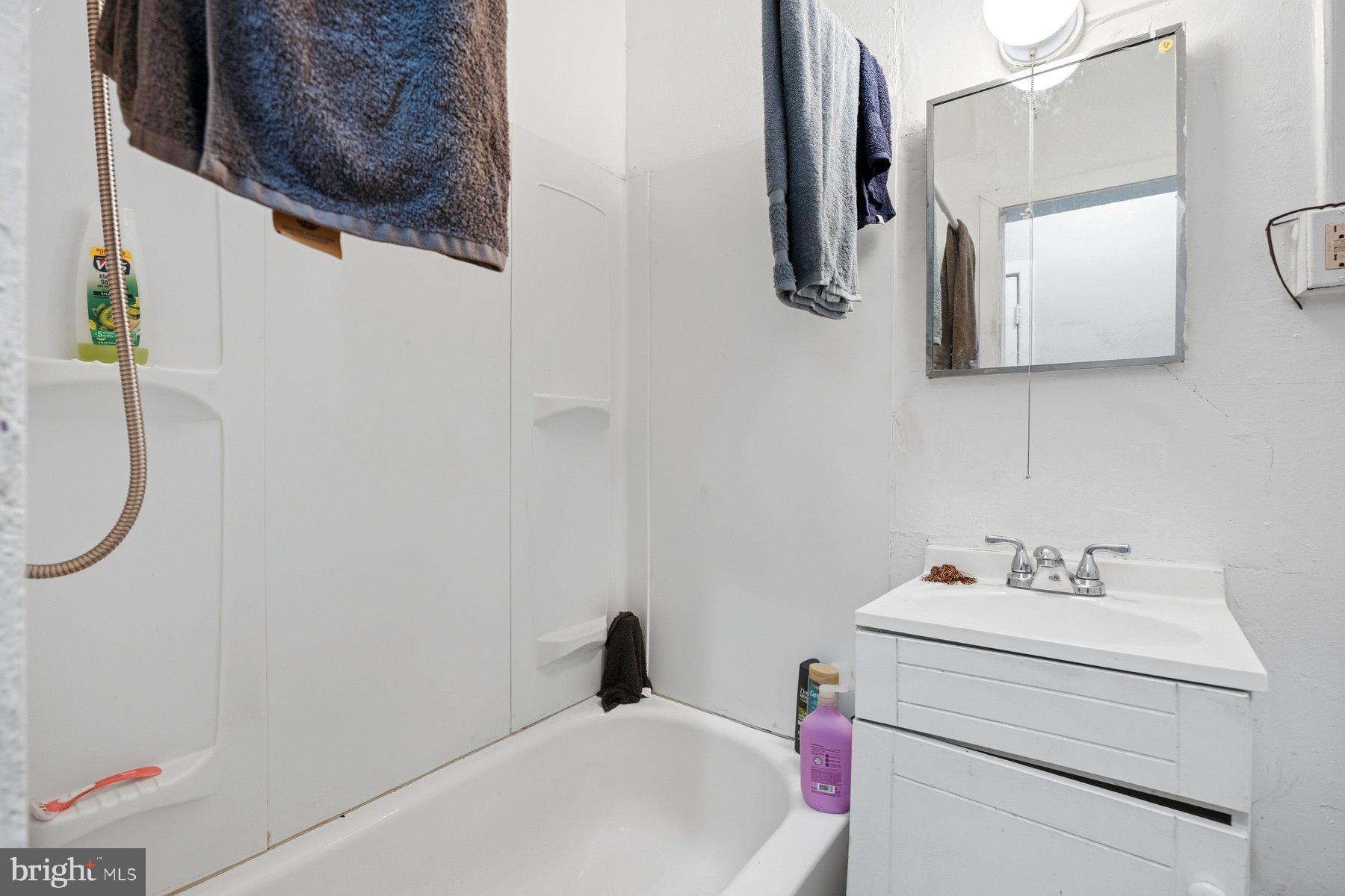 923 1st Street Baltimore, MD 21225 - Photo 13 of 32 a bathroom with a sink and a mirror